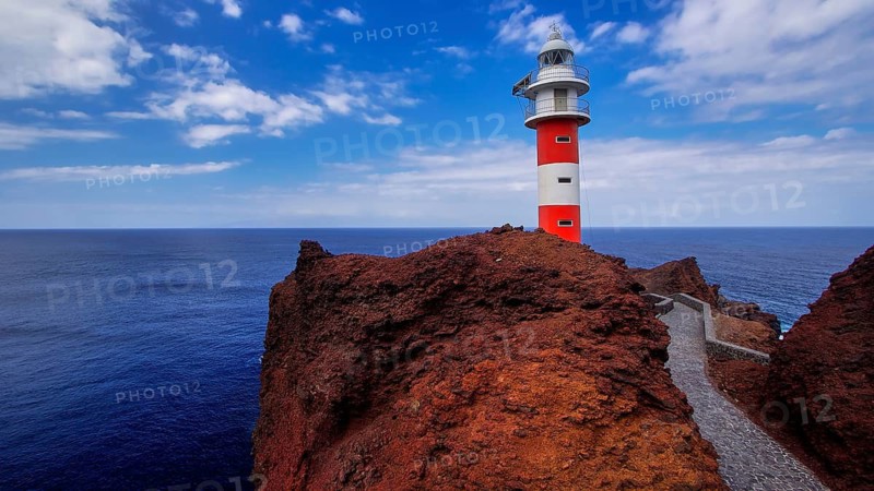 Punta de Teno, red and white lighthouse stands on rugged rock with a wide view of the sea, Masca, Barranco de Masca, canyon, Teno, Teno Mountains, northwestern Tenerife, Tenerife, Canary Islands, Spain