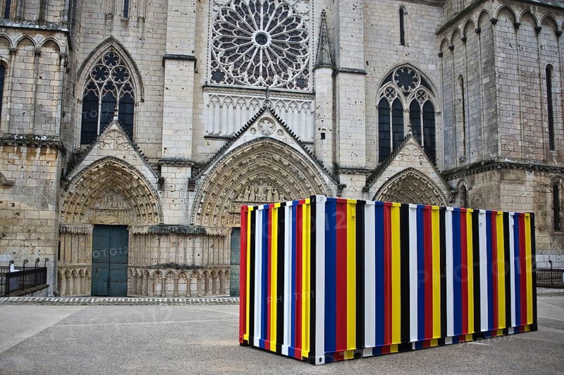 Contemporary art, shipping container in obangsaek colors by Korean artist Kimsooja. Medieval architecture, facade of the Saint Pierre cathedral at Poitiers, France. The cathedral is a 12th-14th centuries gothic monument
