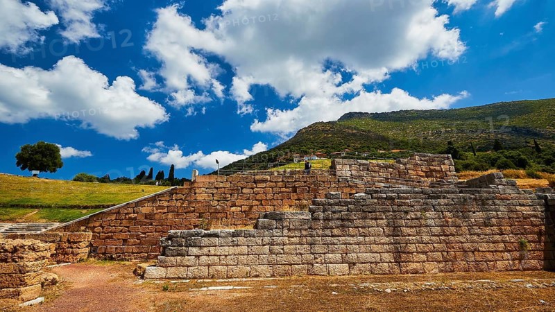 Old stone wall with clouds and green space in the background, ancient site, archaeological site, Messene, Messini, Messinia, southwest of the Peloponnese, odyssey, Odyssey, Odysseus, Ulysses, film, filming location, Matt Damon, Peloponnese, peninsula, Greece