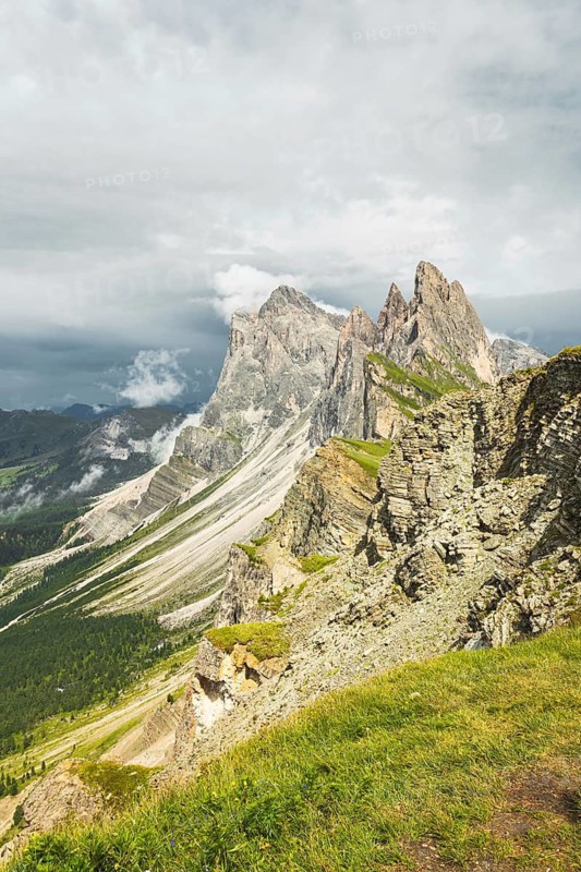 Dramatic Seceda mountain peaks scenic view Dolomites Alps Italy summer daytime green alpine meadow clouds travel destination photography background