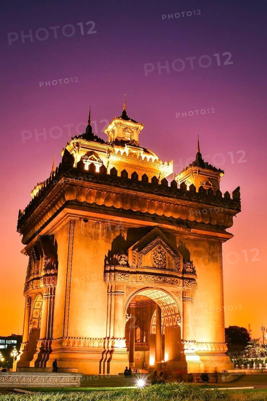 Vientiane, Laos - 15th february, 2025: Patuxai Victory Monument in Vientiane, Laos. The illuminated arch glows golden with purple blue hour sky at sunset