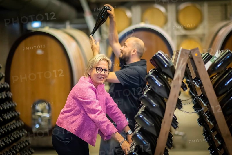 The Saxon Minister of State for Culture and Tourism Barbara Klepsch, together with fountain master Thomas Milster shaking the classic bottled fermentation sparkling wine by hand, Radebeul, Saxony, Germany