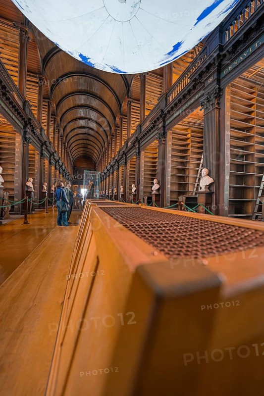 Interior view of a historic library with empty shelf and vaulted ceiling, Trinity Collage, Dublin, Ireland
