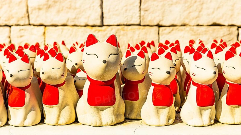 Maneki-neko Japanese-style cat figures in the Wat Phra That Don Phra Chan Buddhist temple, near Lampang, Lampang province, Thailand
