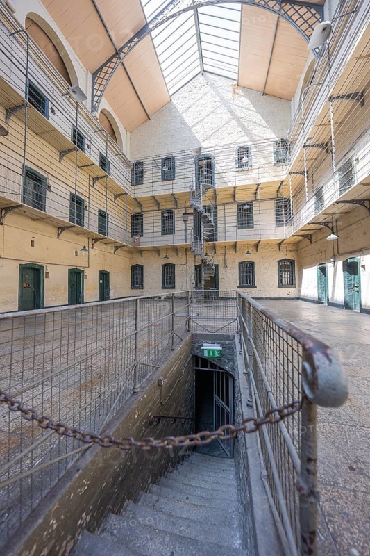 Stairway in an old building with surrounding gallery floors and open skylight, Kilmainham Gaol Prison, Dublin, Ireland