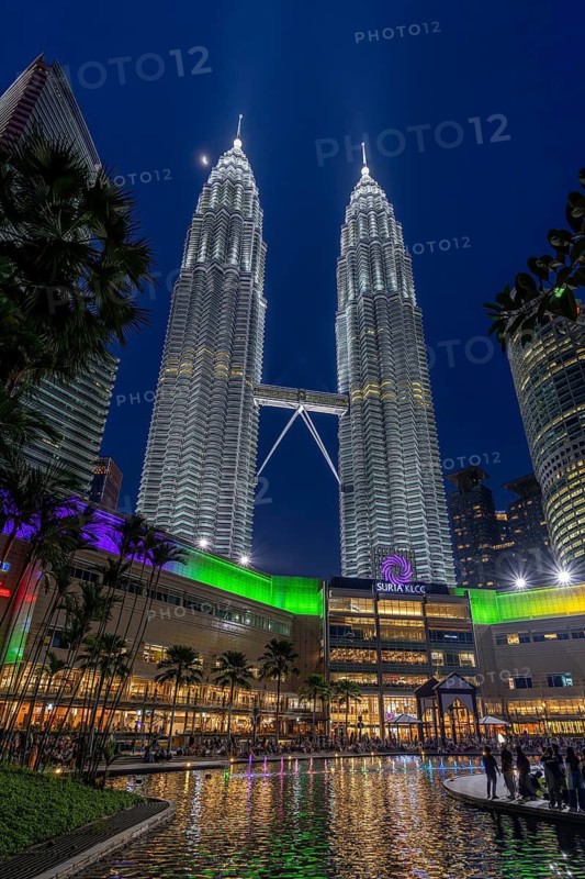 Petronas Towers, KLCC Twin Towers, interlinked 88-storey supertall twin skyscrapers illuminated at night in capital city Kuala Lumpur, Malaysia