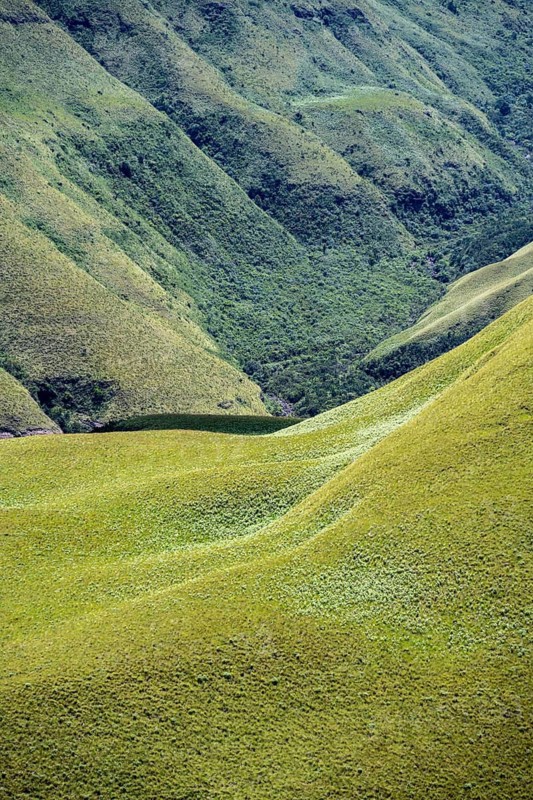 Detail, light and shadow, green meadows and mountain valley, mountain landscape of the Cathedral range, Drakensberg Mountains, KwaZulu-Natal, South Africa