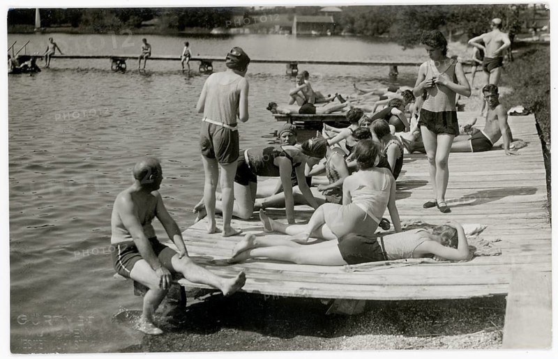 Munich, bathing, swimwear, leisure, summer, swimming, woman, men, outdoor pool, sunbathing, people relaxing on a wooden walkway by the water on a sunny day, 1930
