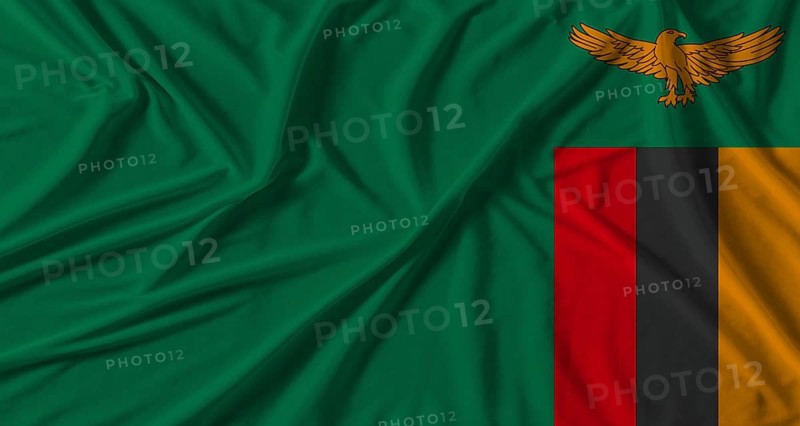 Zambia flag with fabric texture background. National flag of Zambia with cloth texture