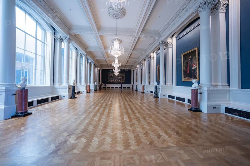 A spacious classic gallery room with parquet floors and high ceilings, decorated with paintings and chandeliers, National Gallery of Ireland, Dublin, Ireland