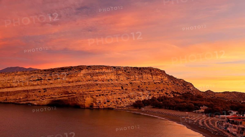Sunrise on a coast with rocks, quiet beach and calm sea, Matala, south coast, Crete, Greek Islands, Greece