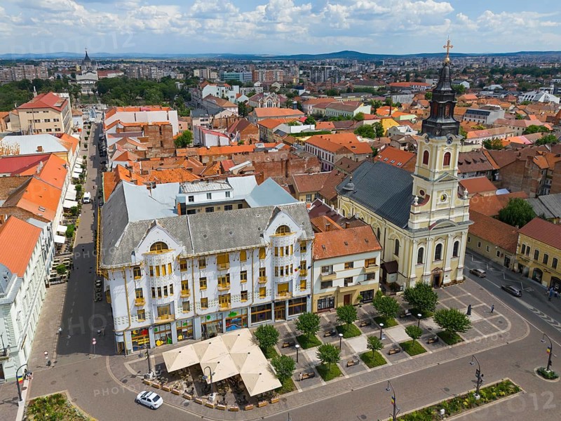 Panorama with historic church, old buildings and red roofs under a sunny sky, aerial view, palace of Adolf Moskovits and sons, Moon Church on the right, Piata Unirii, Unity Square, Oradea, Bihor district, Kreisch region, Transylvania, Romania