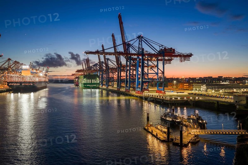 Aerial view at Waltershof harbour during the Blue Hour with Eurogate Container Terminal Hamburg (CTH) and Container Terminal Burchardkai (CTB) with the brightly lit Ever Meed and Manila Express in the background, Hamburg, Germany