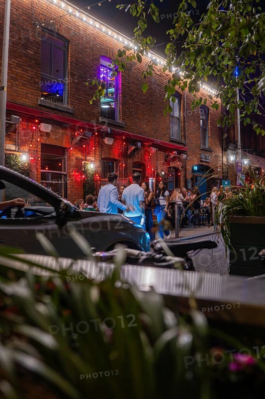 Out at night in front of a lively place with people enjoying the ambiance, Nightlife, Dublin, Ireland