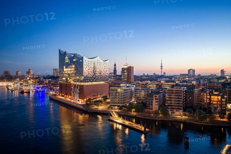 Aerial view of sunrise on the Elbe with Elbe Philharmonic Hall and reflections in the glass façade, Hamburg, Germany