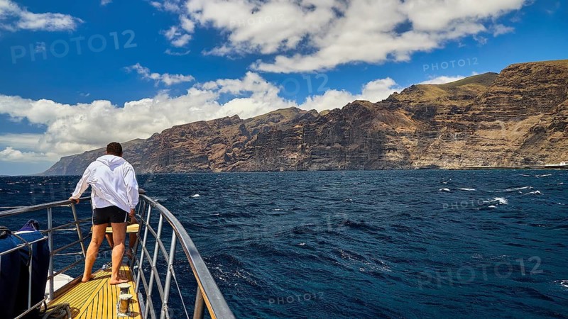 Los Gigantes, A man at the helm of a boat enjoying the view of the rocky coast, whale watching boat tour, whale watching, dolphins, west coast, Tenerife, Canary Islands, Spain