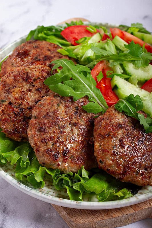 Fried cutlets, mixed minced meat, with vegetable salad, homemade, top view, no people