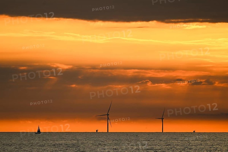 Sailboat, large wind turbines, wind turbines off the coast at sunset, Houvig Beach, North Sea, Denmark