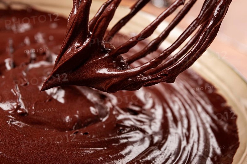 A bowl of chocolate dough, a whisk for whipping, baking, structure and consistency, homemade, top view, no people