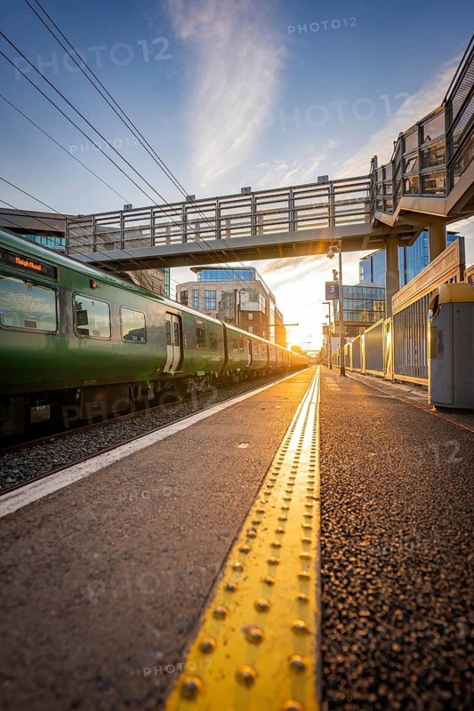 View along a rail with bridge at sunset, surrounded by modern buildings, Dockland, Dublin, Ireland