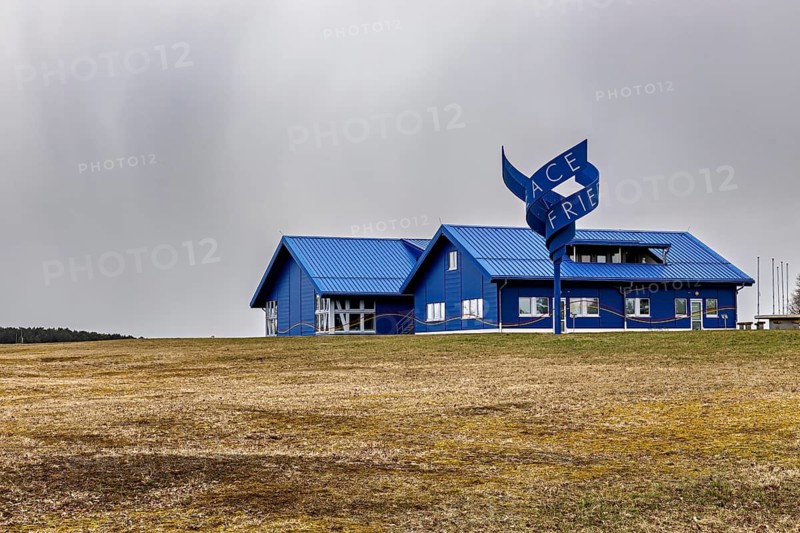 Modern blue building with a wavy sign on a field under cloudy sky, The Point Alpha memorial between Rasdorf and Geisa in the Rhön