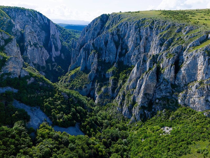 Impressive gorge with steep rocks and thick forest under clear sky, aerial view, Cheile Turzii, Turda Gorge, Thorenburg Gorge, Turda, limestone gorge in the Trascau Mountains, Trascau, nature reserve, Western Carpathians, Transylvania, Romania