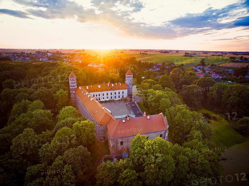 Historical Panemune castle in dramatic sunset conditions with green nature and sunset flare. Birstonas. Lithuania