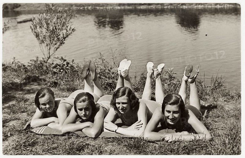 Bathing, swimwear, woman, leisure, fun, summer, Four woman in swimming suits lie belly down by the river and appear relaxed, 1935