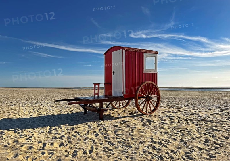A red bathing cart on the west beach with the sea, North Sea island of Borzburg, East Frisia, Lower Saxony, Germany