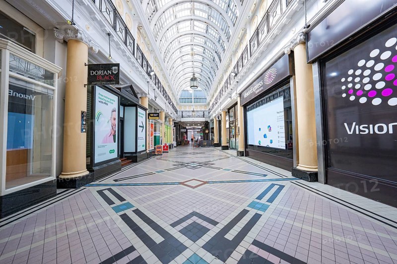 Interior view of a shopping street with glass ceiling and decorative tile floor, Dublin, Ireland