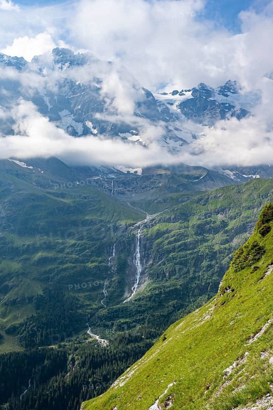 Picturesque mountain landscape with Schmadribachfall waterfall and mountain peaks, Bernese Alps, Bernese Oberland, Switzerland