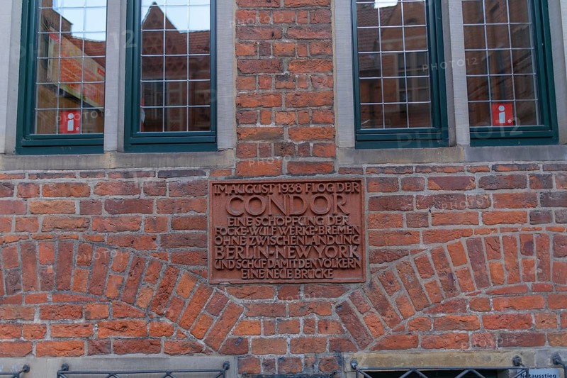Memorial plaque to the flight path record of the Fw 200 V1 Condor in August 1938, historic Böttcherstraße in the old town of the Hanseatic City of Bremen from the 1920s, Bremer Fockerwerke, production of airplanes, route from Berlin to New York, example of clinker expressionism architecture, brick architecture, tourist information, popular tourist destination, Germany