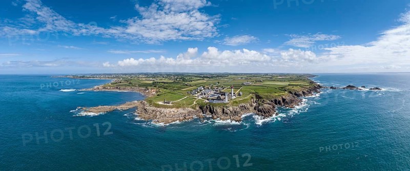 Aerial view, panorama of the distinctive red and white lighthouse Phare de Saint-Mathieu on the Breton coast next to the historic church ruins of the former Benedictine Abbey of Saint-Mathieu de Fine-Terre, next to a white marine signal pole also called Sémaphor, Pointe Saint-Mathieu, Plougonvelin, Finistère department, Brittany region, France
