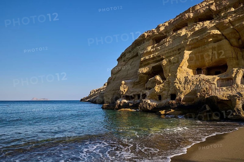 Neolithic caves, former hippie paradise, rocky coastline with caves and calm waves on a sunny day, Matala, south coast, Crete, Greek Islands, Greece