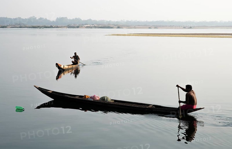 Mahanadi river, local fishermen, Sonepur, Odisha, India. The bottle on the surface of the water is a fish trap