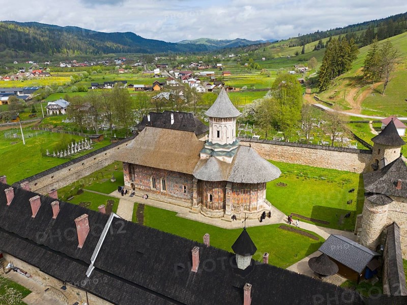 View of a picturesque church within a monastery area surrounded by hills and trees, aerial view, Moldovita Monastery, Moldovita, UNESCO World Heritage Site, Suceava County, Bukovina Region, Romania
