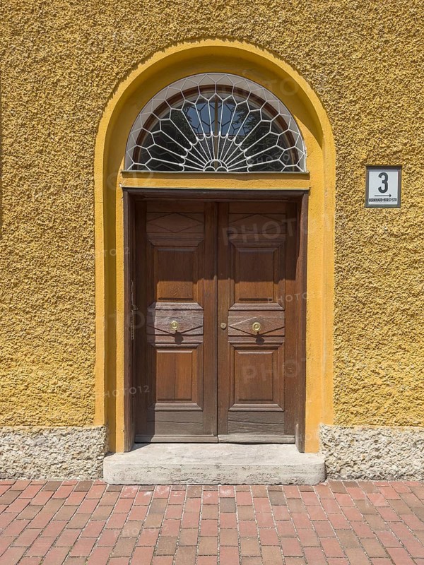 Yellow residential buildings, entrance door, borstei, heritage-protected residential development, Munich, Bavaria, Germany