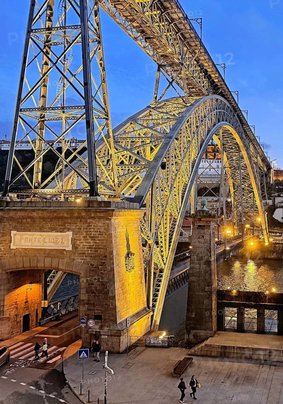 Illuminated arch bridge Ponte Dom Luis I designed by Théophile Seyrig, looking towards Vila Nova de Gaia in the evening, Porto, Portugal