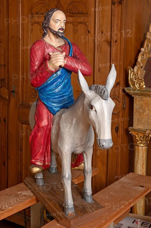 Palm tree, late Gothic figure of Christ, modern donkey, parish church of St. Lawrence, Otzing, Deggendorf district. Lower Bavaria, Germany