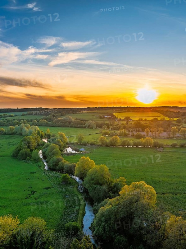 Sunset of Fields and Farms over Horsebridge nad Stockbridge from a drone, Hampshire, England, United Kingdom