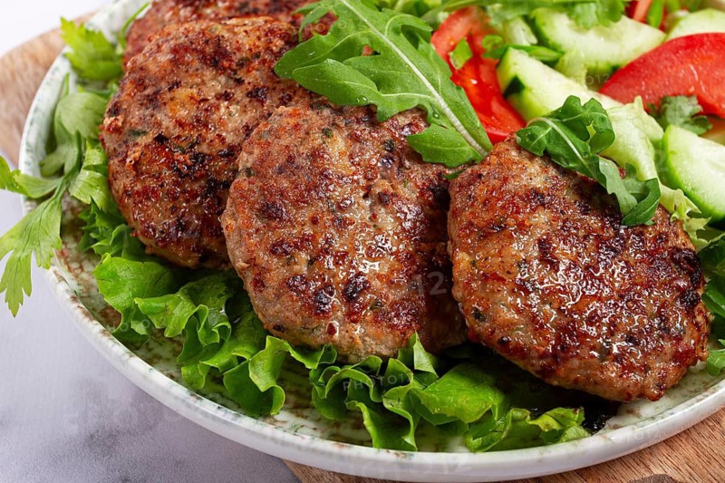 Fried cutlets, mixed minced meat, with vegetable salad, homemade, top view, no people