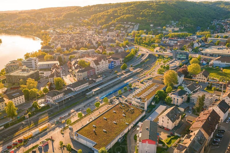 Panorama of a city with a river and mountains in the background under a sunny sky, electrification of the Hochrheinbahn, conversion of the railway station, Waldshut, Tiengen, Germany