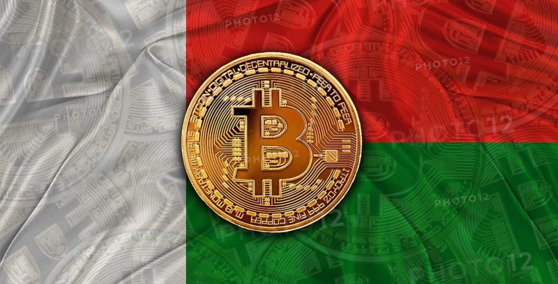 Investors in Blockchain Technology with Madagascar flag background. Bitcoin cryptocurrency with Malagasy flag