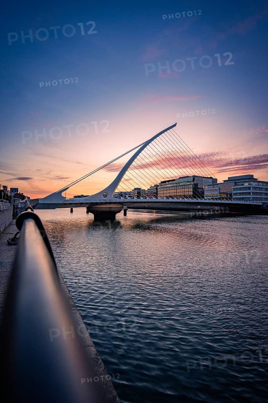 Modern Samuel Beckett Brg, bridge over a river at sunset surrounded by municipal buildings, Dublin, Ireland