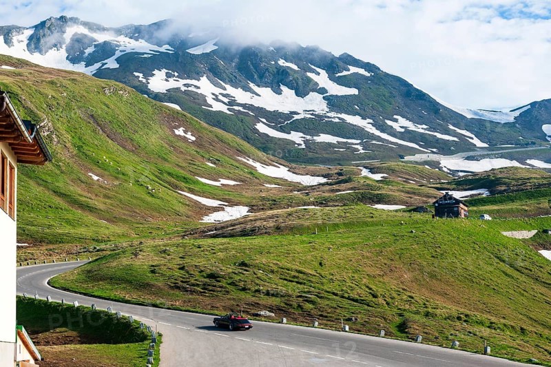 Porsche 911 964 drives on south ramp from Grossglockner High Alpine Road towards Hochtor, Grossglockner High Alpine Road, Heiligenblut, Carinthia, Austria