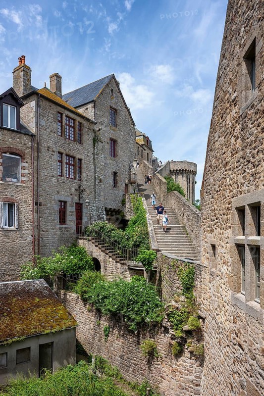 Historic stone steps and narrow streets between medieval buildings on the Mont-Saint-Michel monastery island, tourist attraction, UNESCO World Heritage Site, Pontorson, Manche department, Normandy, France