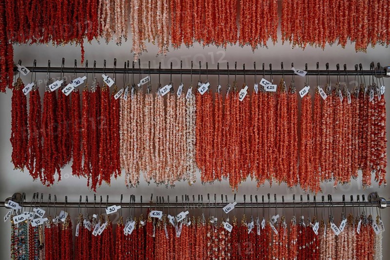 Sale of real corals, coral necklaces in pink, light red and red, Taormina, Sicily, Italy