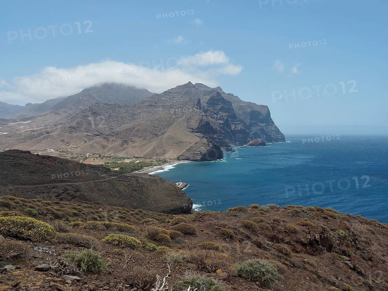 Breathtaking coastal landscape with mountains and sea under clear sky, La Aldea de San Nicolas, Gran Canaria, Spain