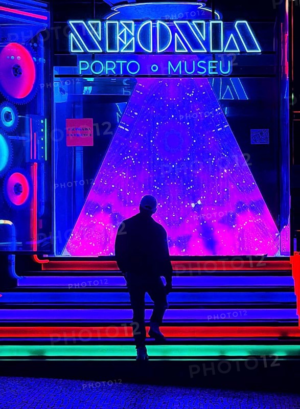 A man walks up the stairs to Neonia, an immersive museum that combines art, science and the history of the city in interactive spaces, Porto, Portugal