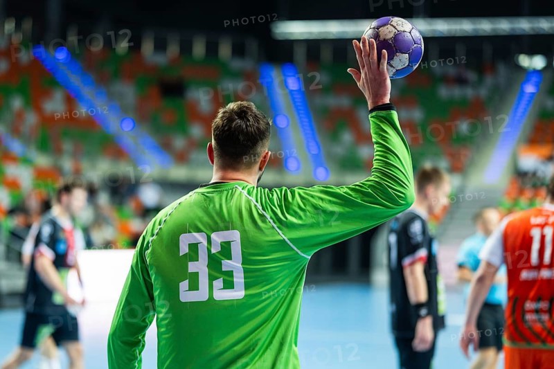 Handball goalkeeper throws ball during the match in Lubin, Poland